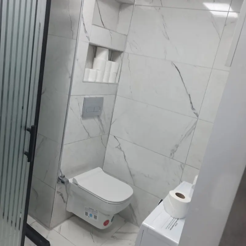 Beyaz mermer desenli banyo ve asma klozet